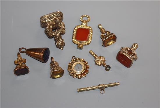 Seven assorted 19th century and later yellow metal overlaid fob seals, propelling pencil, watch key and compass.